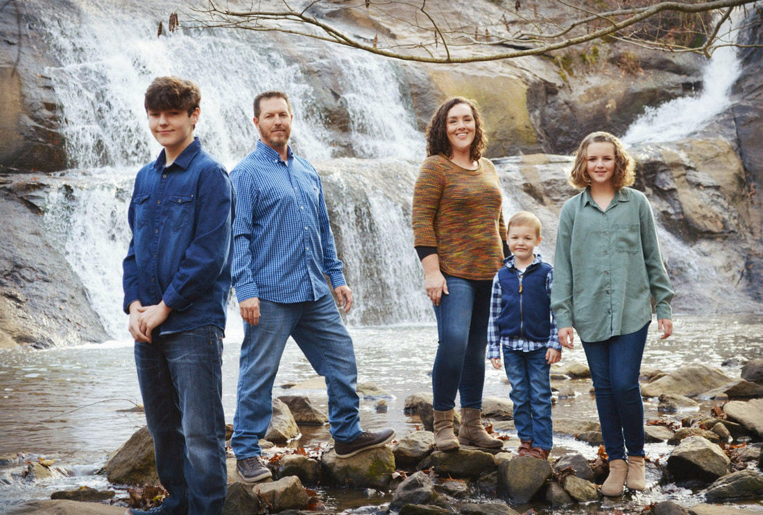 Picture of Riley family at waterfall.